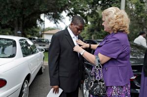 In a suit too big, Davion's case worker adjusts his tie outside the church. TAMPA BAY TIMES